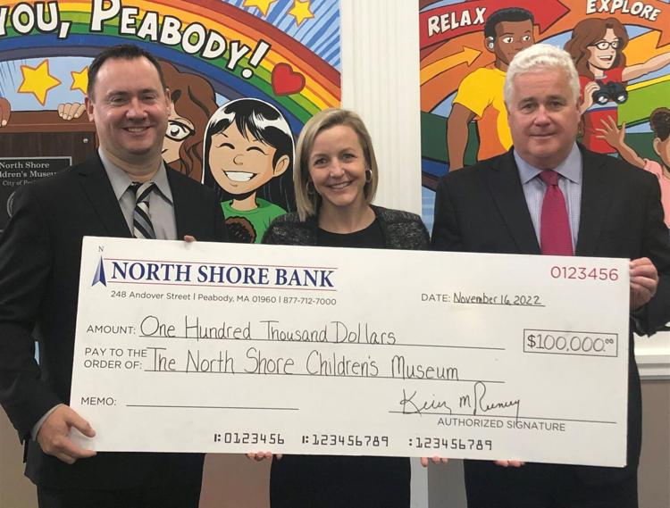 (Left to right) Mayor Ted Bettencourt of Peabody, MA, North Shore Children's Museum Executive Director Ali Haydock, and North Shore Bank CEO Kevin Tierney pose with a $100,000 check donated from the bank to the museum.