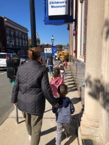 Students and teacher heading to their bus after a field trip to North Shore Children's Museum