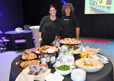 Ladies from Toscana restaurant in front of their table with food for the gala