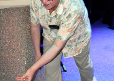 A man throwing a ball, camera caught mid action at the gala event