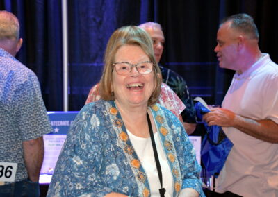An older woman smiling for the camera at the gala