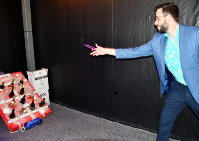 A man wearing glasses throwing a ring toss