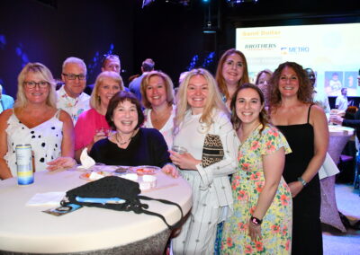 A group of adults posing for the camera at the grown ups gala for NSCM